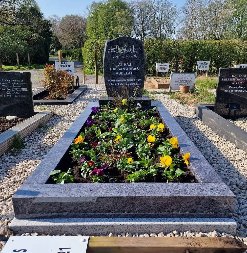 The Abdelati memorial with a shaped headstone and planted surround